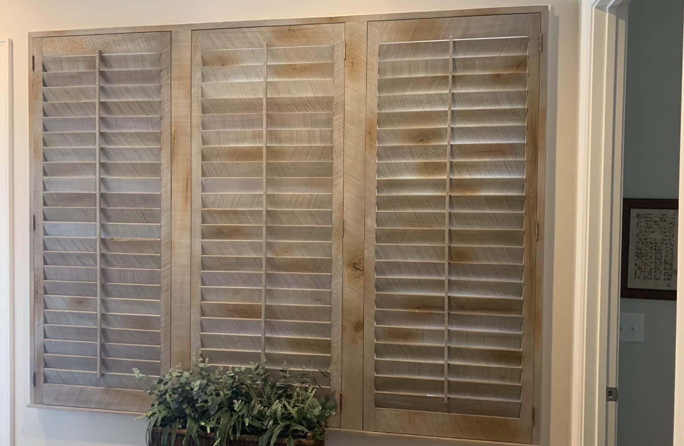 Reclaimed wood shutters above plant